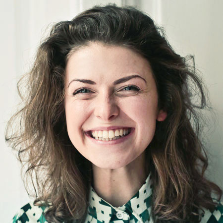 close up of smiling female with wavy hair